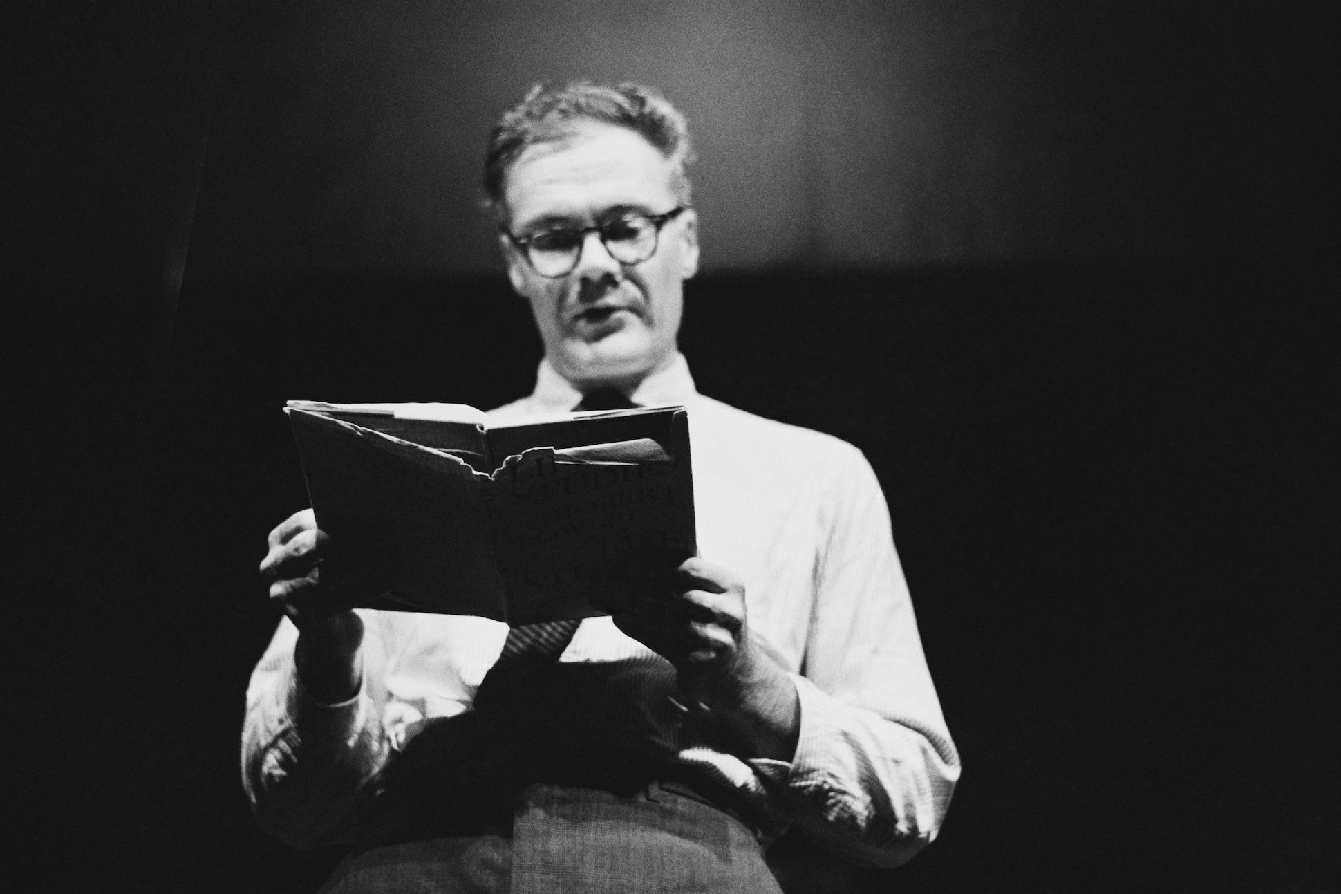 American poet Robert Lowell (1917 - 1977) reading a poem at a Poetry Festival held at the Royal Court Theatre, London, UK, July 15th to 20th, 1963.
