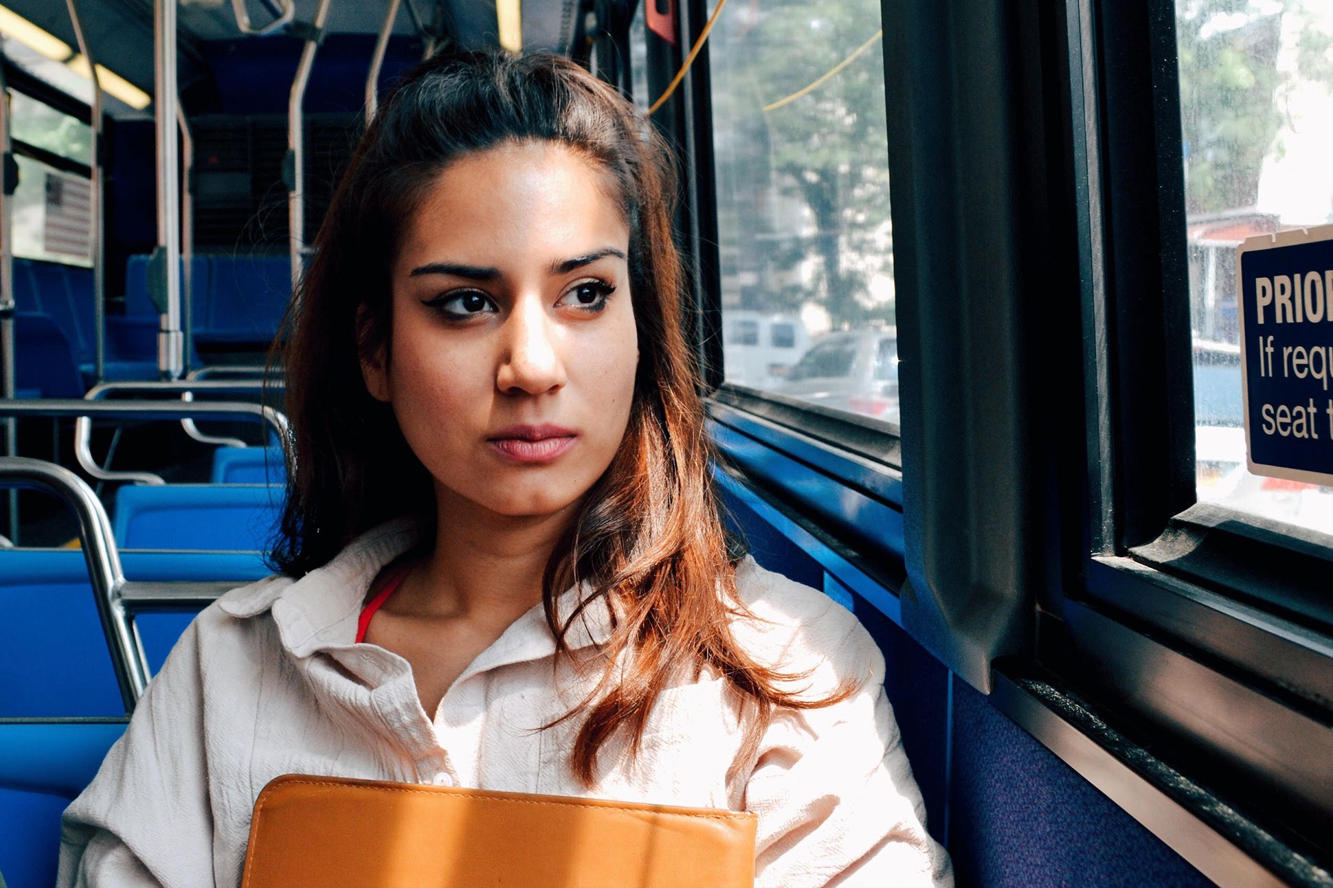 Photo of poet Aria Aber on a bus