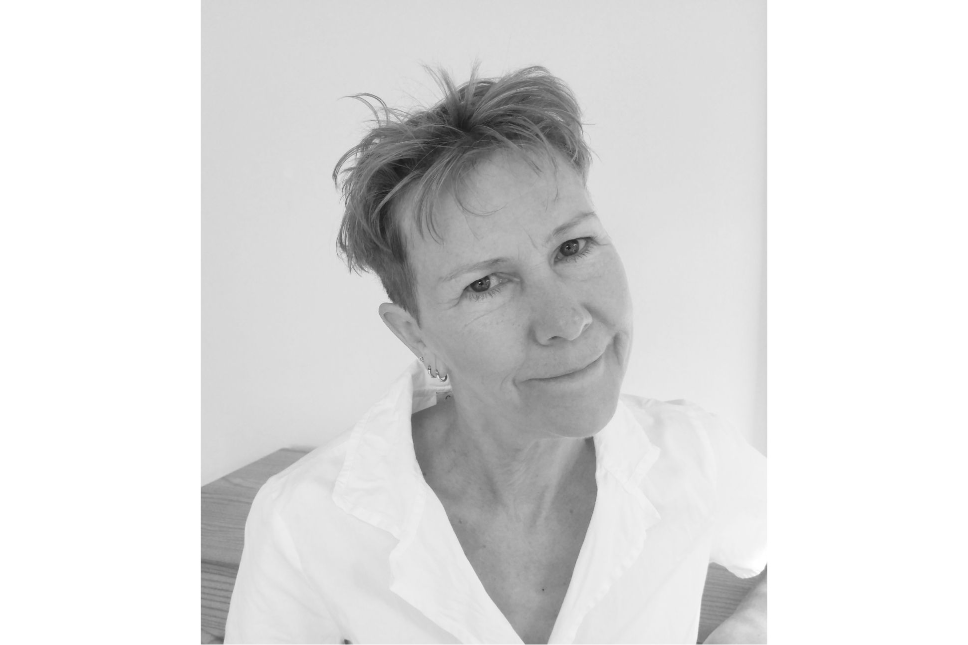 Black and white portrait of a short-haired white woman in a shirt