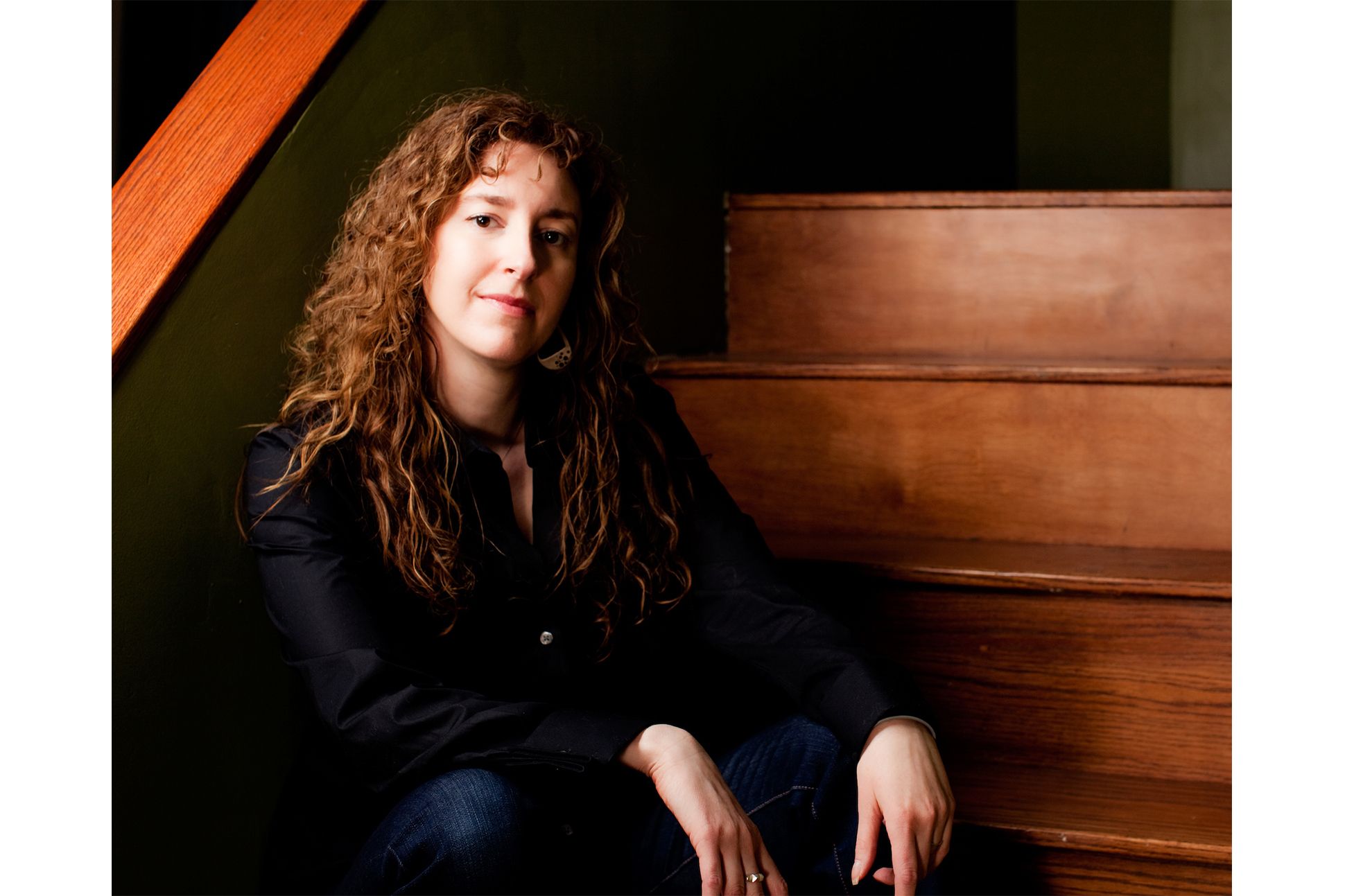 Poet Sharon Gottula sitting on a staircase