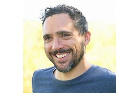 A man smiling in blue t-shirt