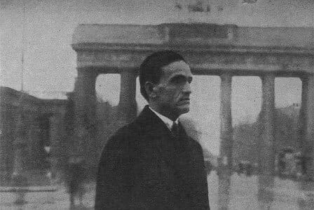 Poet Cesar Vallejo standing in front of the Brandenburg Gate in Berlin