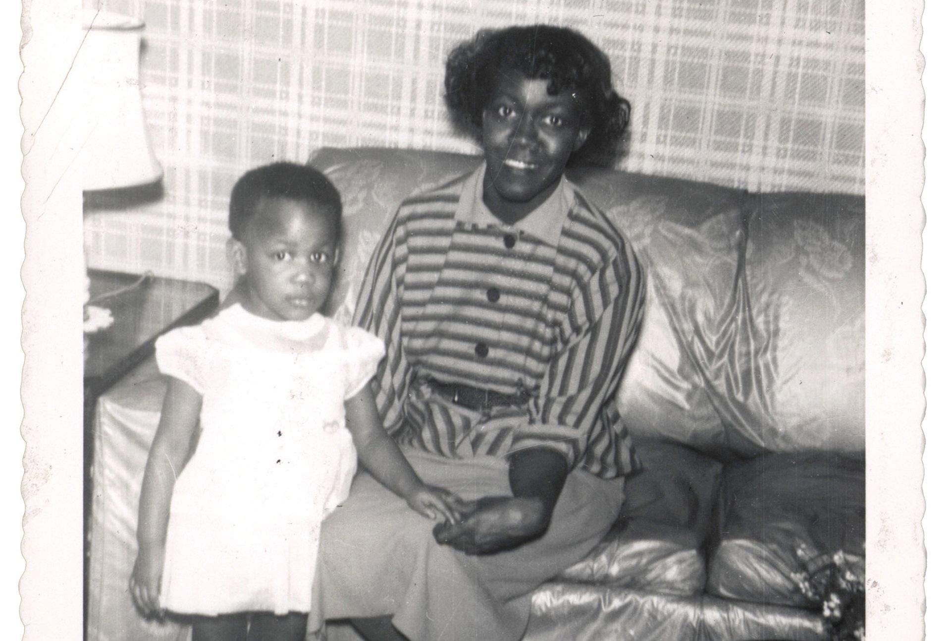 Black and white photograph of the poet Gwendolyn Brooks sitting on the couch with her daughter, Nora Blakely.