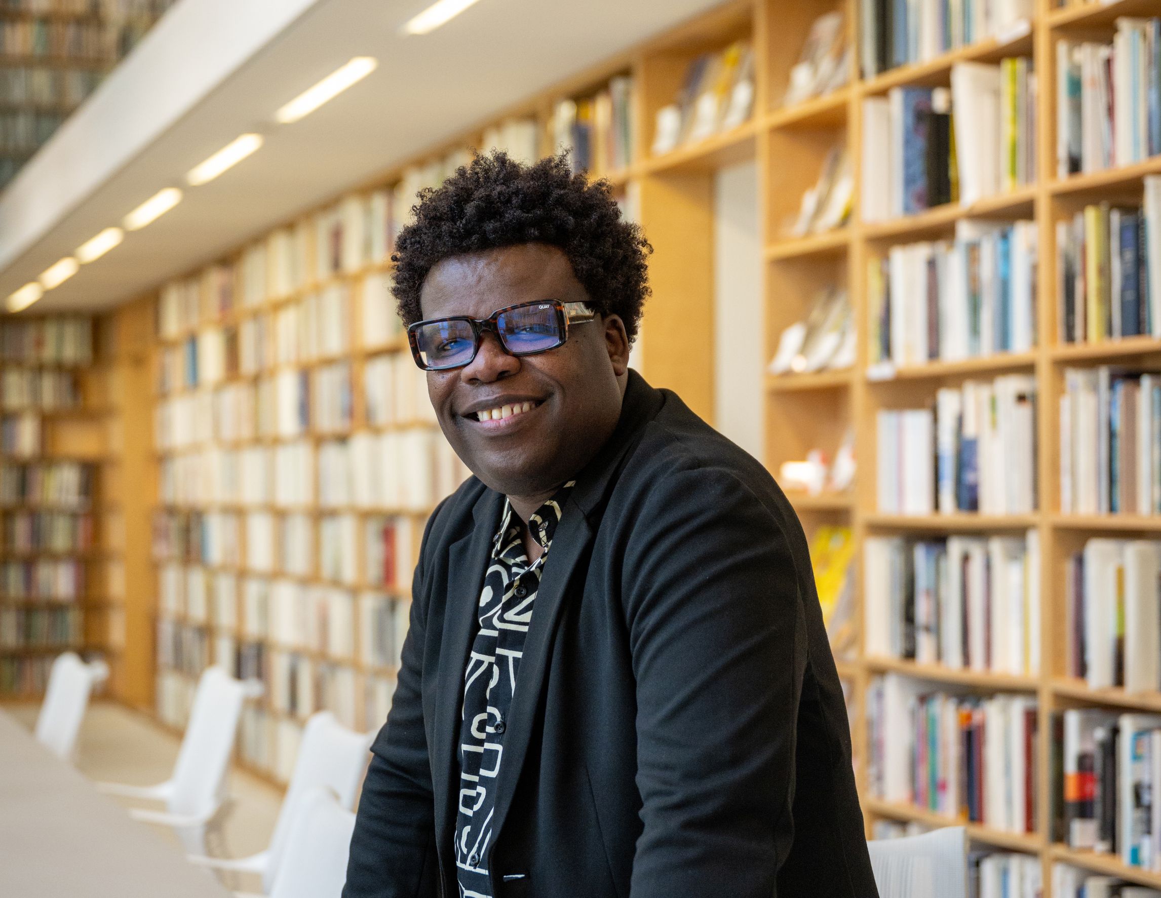 avery r. young smiling in the Poetry Foundation library