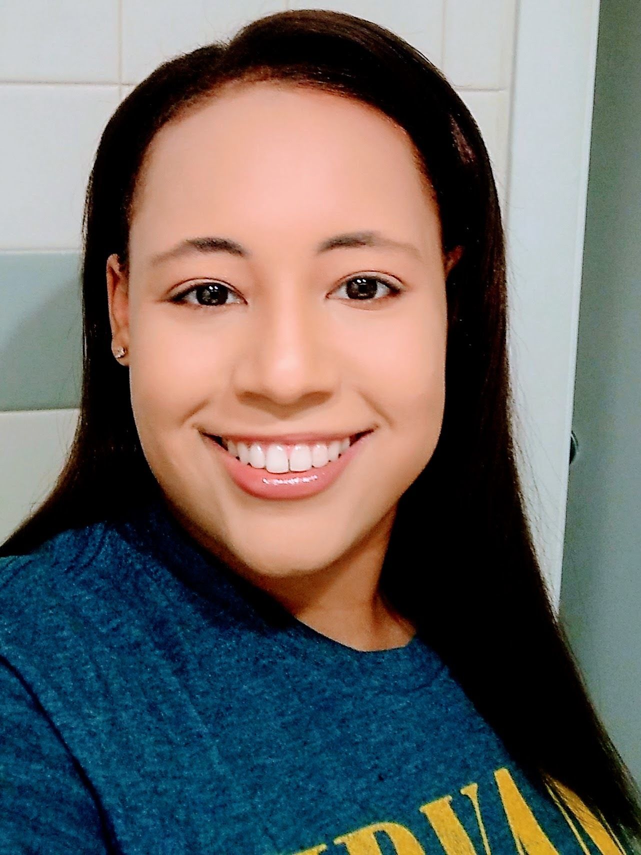 Joy Young, a black woman with brown hair smiling.