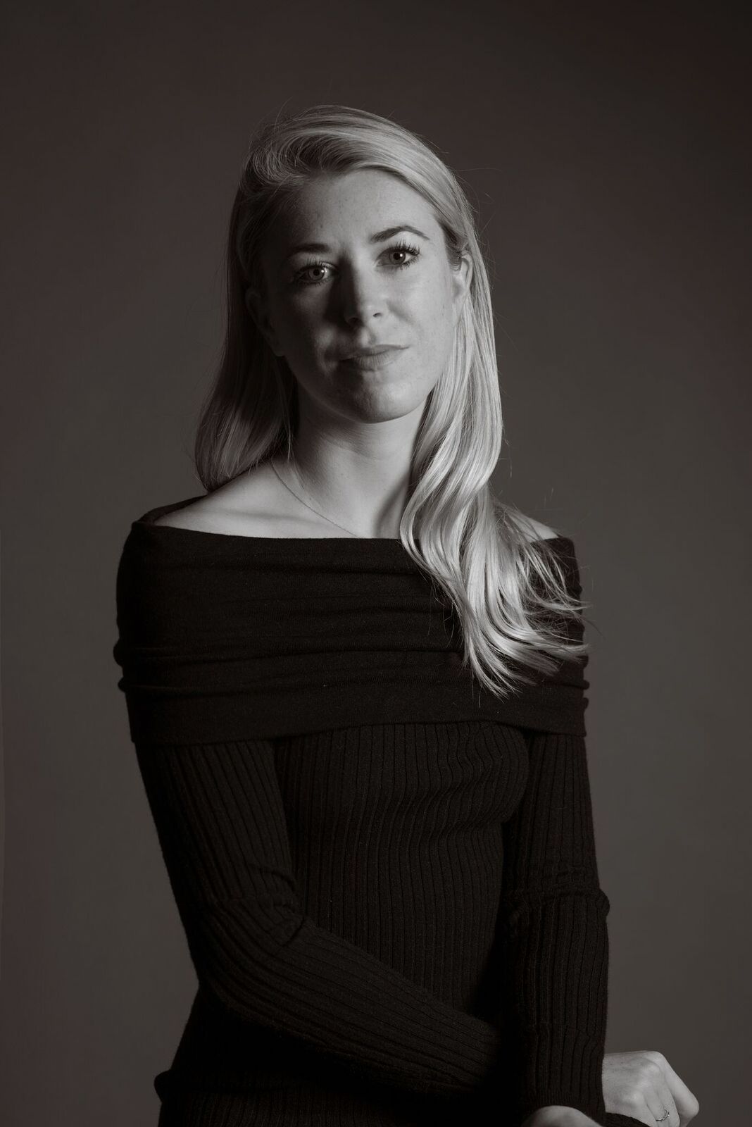 Constance Jaeggi, a white woman with blonde hair sits in front of a grey backdrop